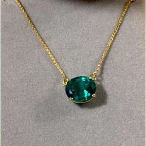 Man made emerald pendant necklace, set in 14K gold